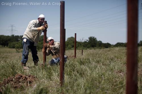 Workers install a fence on the 77 Ranch as part of Water As A Crop’s cost-share program to promote sustainable land management. 